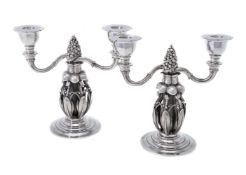 Georg Jensen, a pair of Danish silver Fir Cone twin light candelabra