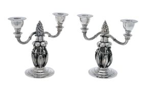 Georg Jensen, a pair of Danish silver Fir Cone twin light candelabra