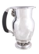 ϒ Georg Jensen, a Danish silver Grape pattern pitcher or jug