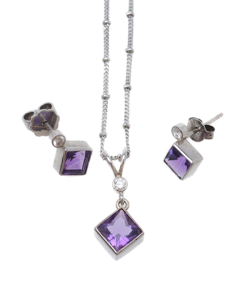 An amethyst and diamond pendant and ear studs