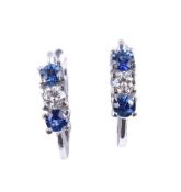 A pair of sapphire and diamond three stone earrings