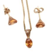 A pair of spessartite garnet ear studs and necklace