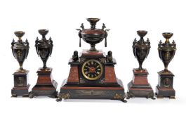 A French gilt and patinated bronze mounted marble five-piece mantel clock garniture in the Egyptian