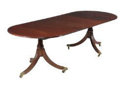 A mahogany twin pedestal extending dining table