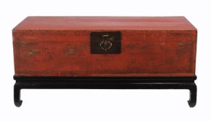 A Chinese red lacquered elm chest on stand