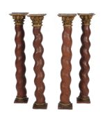 A set of four carved, painted and parcel giltwood and composition Solomonic columns,