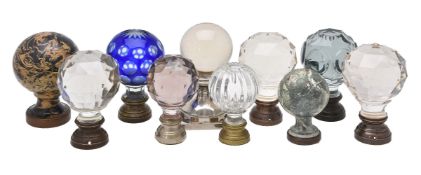 A group of ten assorted glass and metal mounted newel finials