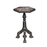 A carved and ebonised wood and marble mounted occasional table in Neoclassical style