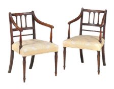 A pair of late George III mahogany armchairs