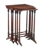 A nest of three mahogany occasional tables