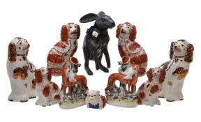 An assortment of mostly Staffordshire pottery animals