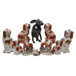 An assortment of mostly Staffordshire pottery animals