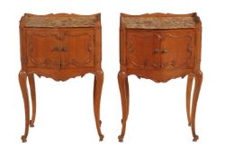 A pair of French chestnut and marble topped bedside tables in Louis XVI style