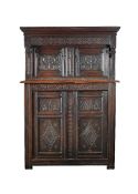 A carved oak court cupboard in Charles II style