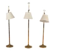 A set of three brass standard lamps