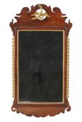 A George III carved mahogany and parcel gilt wall mirror