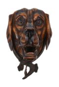 A Continental carved and stained wood and metal mounted hound's head wall mount