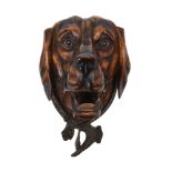 A Continental carved and stained wood and metal mounted hound's head wall mount