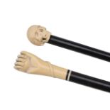 ϒ Two late Victorian or Edwardian carved ivory and ebonised wood walking sticks