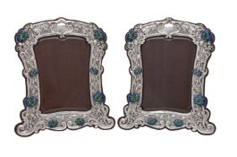 A pair of Art Nouveau silver and enamel photograph frames by William Neale & Sons