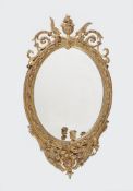 A Victorian oval giltwood and composition girandole wall mirror