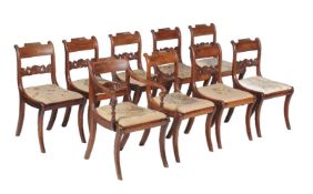 A set of nine Regency mahogany and brass strung dining chairs