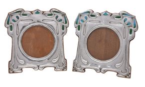 A pair of Arts and Crafts silver and enamel photograph frames by William Hutton & Sons