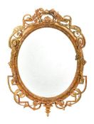 A giltwood and composition oval wall mirror