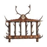 An Edwardian oak and antler mounted wall hanging hat and coat rack
