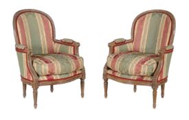 A pair of limed walnut armchairs in Louis XVI style