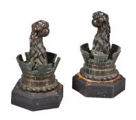 A pair of Victorian bronze mounted cast iron andirons or finials in Gothic taste