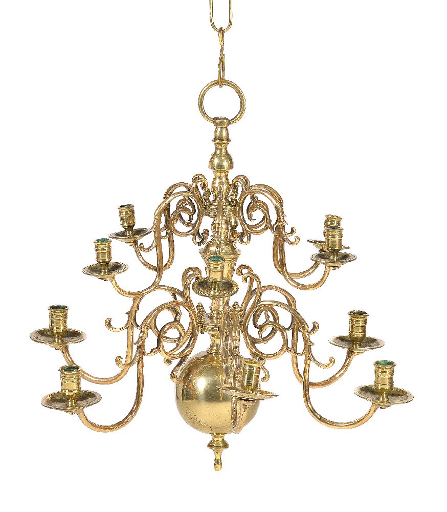 A Dutch brass twelve light chandelier