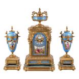 A gilt metal and blue Sevres style porcelain clock garniture