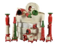 A collection of five naval fire hoses and three detachable fire nozzles