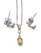 A diamond and yellow sapphire pendant and ear studs