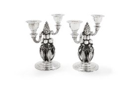 Georg Jensen, a pair of Danish silver Fir Cone twin light candelabra