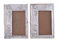 A matched pair of Arts and Crafts silver photograph frames