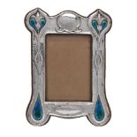 An Arts and Crafts silver and enamel photograph frame by Deakin & Francis