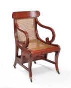 A Regency red lacquered metamorphic library armchair