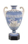 A Turner pale-blue solid-jasper two-handled urn on polished black basalt base