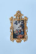 A Chinese reverse-glass and carved giltwood wall mirror