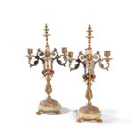 A pair of French gilt metal, onyx and champlevé enamel four light candelabra