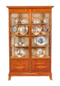 An Edwardian satinwood and inlaid display cabinet