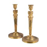 A pair of Continental, probably Russian, ormolu candlesticks in Empire style