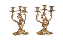 A pair of Rococo Revival gilt bronze three light candelabra