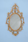 A George III carved giltwood oval wall mirror