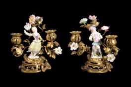 A pair of Meissen and Paris porcelain mounted gilt metal twin light candelabra in Louis XV style