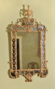 A George III carved giltwood and gesso wall mirror in the manner of Thomas Chippendale