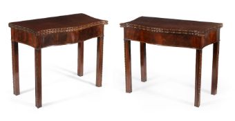 A pair of George III mahogany serpentine folding card tables