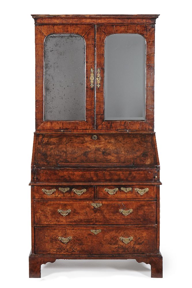 A George I walnut and featherbanded bureau bookcase